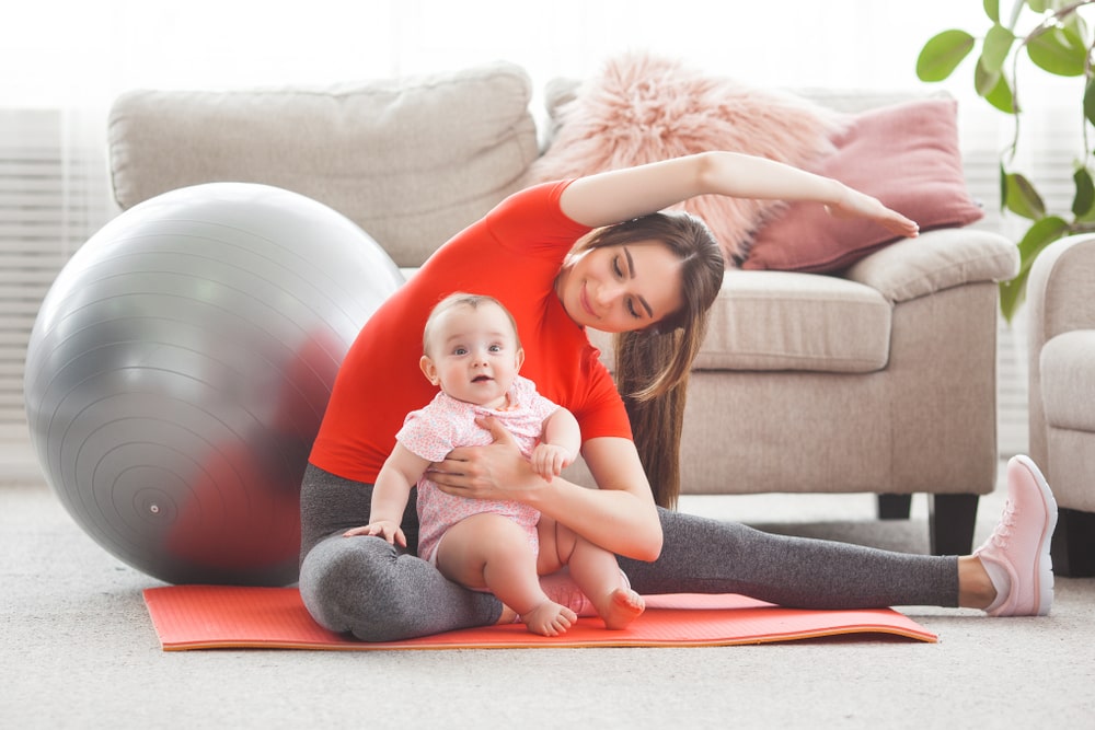 healthy woman doing yoga post partum - The Role of Chiropractic Care in Pregnancy and Childbirth