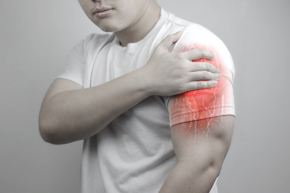 a man suffering from muscle pain - Signs and Symptoms That Indicate a Need for Chiropractic Care