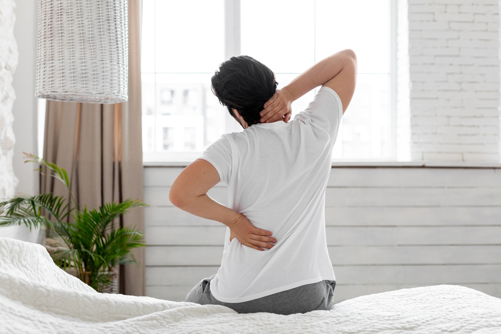 guy suffering from back pain - The Long-Term Benefits of Regular Chiropractic Care