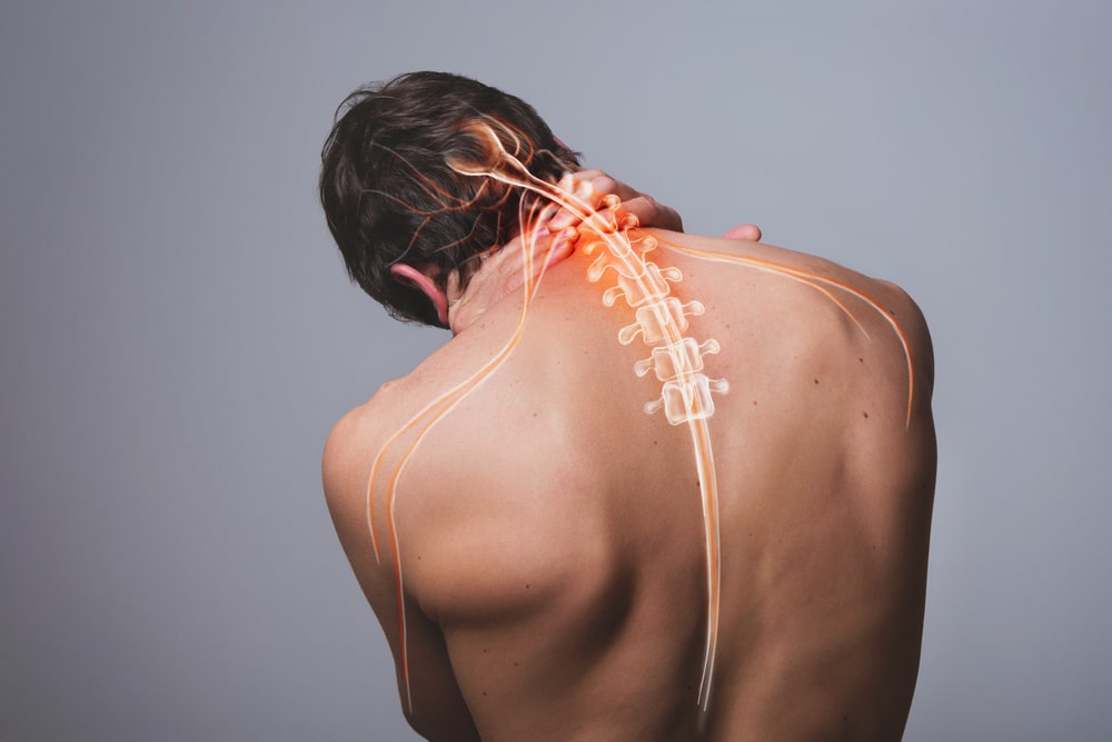 painful area of a man's back, depicting the diverse symptoms addressed by Enlightened Chiropractic through modern chiropractic techniques