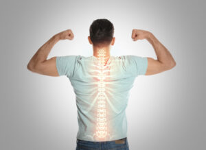 Man with a healthy back on a light background, highlighting the importance of chiropractic care for pain prevention.