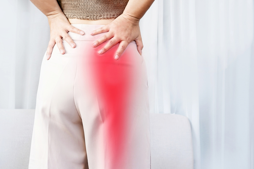 Concept of Sciatica pain featuring a woman experiencing buttock pain radiating to the lower leg, emphasizing the role of a New Orleans chiropractor in treatment.