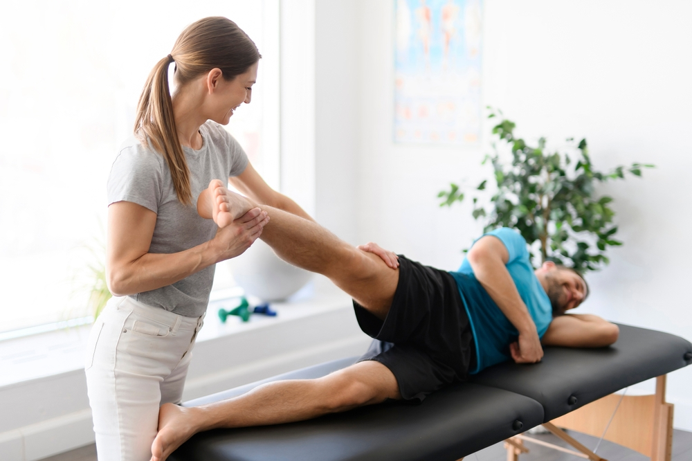 New Orleans chiropractor guiding a mal patient through exercises for a strong back and proper posture during a session at Enlightened Chiropractic.