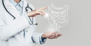 Female doctor holding a virtual model of intestines, illustrating the medical aspect of digestive health in a grey HDR color scheme.