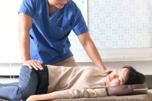 A skilled chiropractor and a patient engaging in a therapeutic chiropractic adjustment session. New Orleans Chiropractor.
